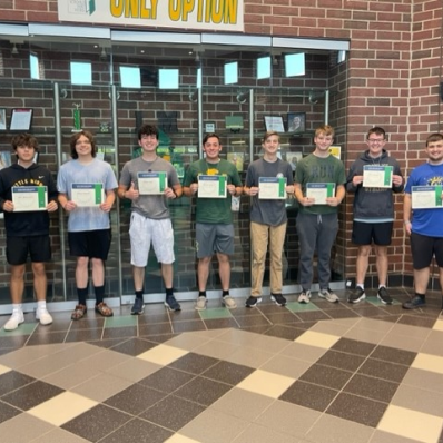 students smiling holding certificate